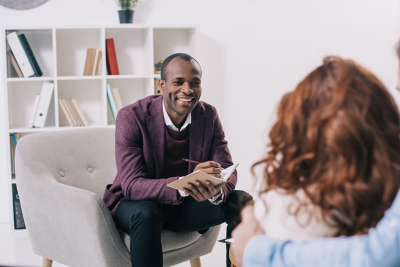 Smiling psychologist with a client