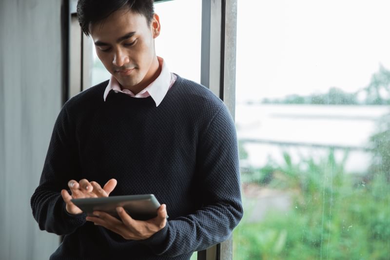 A business analytics expert is looking at an iPad.