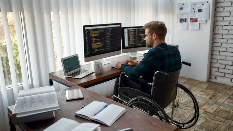 "A data scientist sits at a desk examining data on a computer screen."