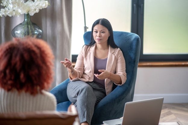 A psychologist talks to a patient.