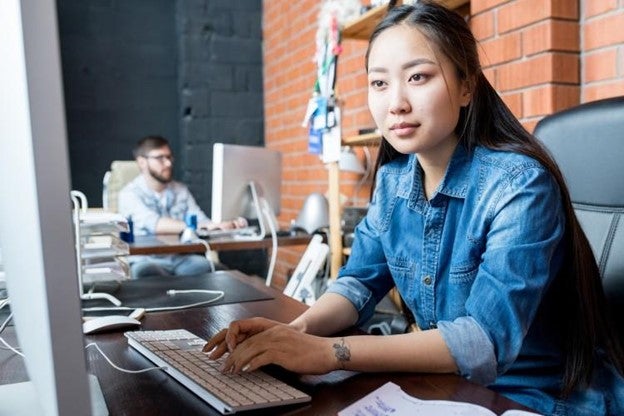 A data scientist works at a computer.