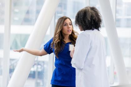 Female healthcare professionals disagree about a patient diagnosis.