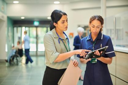 Two healthcare colleagues discussing results. 